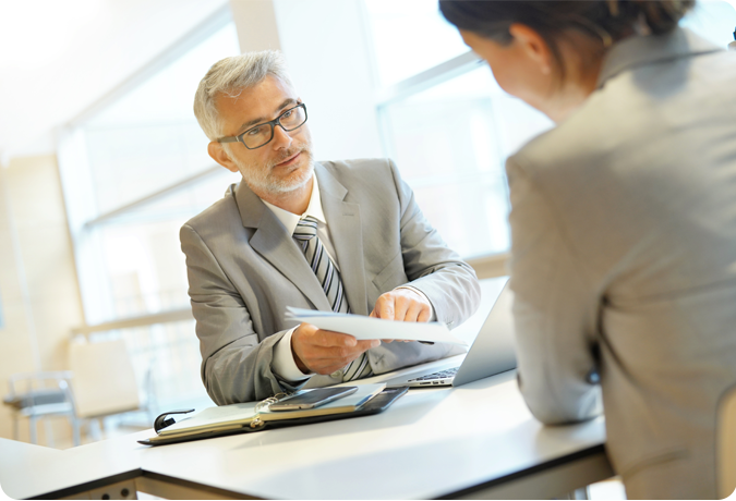 Man handing loan papers to woman